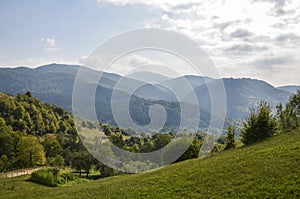 Landscape view on the beautiful hill with houses and trees in morning mountains near the Kvasy village. Carpathians
