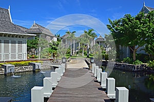 Landscape View of Beautiful upscale resort hotel with small wooden bridge connecting the walkway with the villas