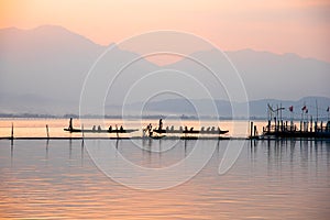 Landscape view - boatman paddle boat in the lagoon lake.Kwan phalandscape view - boatman yao in evenign time at phayao thailand