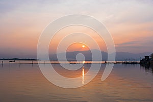 Landscape view - boatman paddle boat in the lagoon lake.Kwan phayao in evening time at phayao thailand