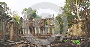 Landscape view of demolished stone architecture and aerial tree root at Preah Khan temple Angkor Wat complex, Siem Reap Cambodia.