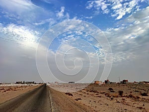 Landscape view of desert with a single road in sunny morning in western sahara