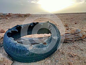 Landscape view of desert with a wrecked tyre in sunny morning.