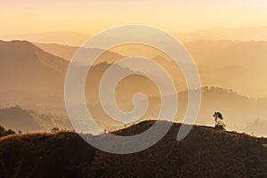 Landscape view in early morning before the sunrise with misty covered mountain hills