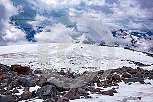 Landscape view of glacier and alpinists climbing by the path.