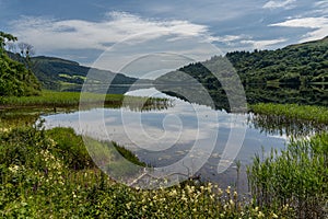 Landscape view of Glencar Lough in western Ireland with sky reflections in the calm lake water