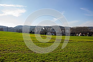 Landscape view of green grass field with blue skybackground