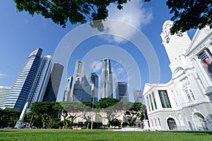 landscape view green park lawn area with skyscraper highrise building skyscrapers in the central business district of Singapore.