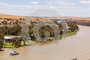 Landscape view of houseboat cruising upstream on the Murray River near Young Husband in South Australia