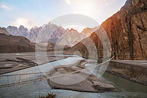 Landscape view of Hussaini hanging bridge above Hunza river, surrounded by mountains. Pakistan.