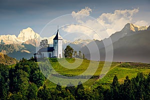 Landscape view of Jamnik church and generic mountains - composite image, Slovenia