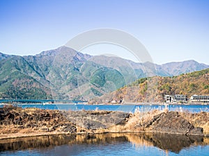 landscape view from kawaguchi lake with bridge , town and mountain background (soft focus) from japan