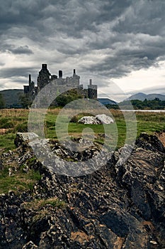 Landscape view of the Kilchurn Castle in Lochawe, Scotland against a clouded sky
