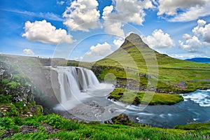 Landscape view of Kirkjufellsfoss In the daytime, blue sky and beautiful clouds. The waterfall is famous and a popular tourist