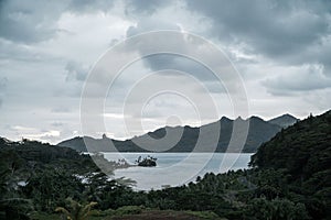 Landscape view of the lagoon and island of Huahine in French Polynesia on a foggy day