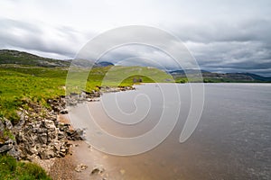 Landscape view of Loch Assynt with the ruins of the Calda House in the background photo
