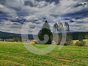 Meadow with Novohrad mountines on background photo