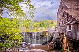 Landscape view of the millpond, waterfall, and gristmill at Historic Yates Mill County Park