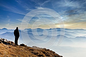 Landscape view of misty mountain hills and man silhouette, Slovakia