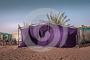 Landscape view of modern purple bedouin`s tent.