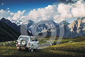 Landscape view of mountain range and offroad car in the meadow, Svaneti national park, Georgia