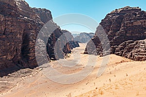 Landscape view of mountains and desert from atop a sand dune.