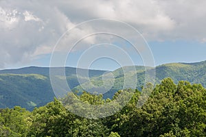 Landscape view of mountains, trees, and grassland at Cades Cove Park