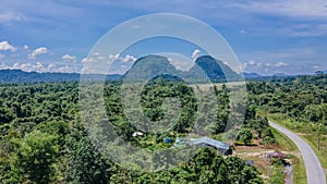 Landscape view of Mulu village with road, tropical forest and mountains near Gunung Mulu national park. Borneo. Sarawak.