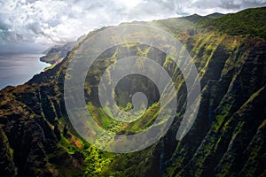 Landscape view of Na Pali coastline cliffs with sunlight glow, Kauai, Hawaii photo