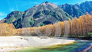 landscape view of nature Kamikochi National Park in fall season with leaves change colors and clear water river