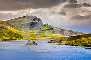 Landscape view of Old Man of Storr rock formation and lake, Scot