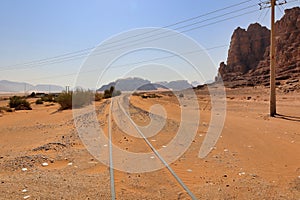 landscape view of old rails in wadi rum desert