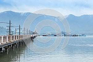 Landscape view of public lighthouse on pier of Salak Phet fishing village Salak Phet bay at Koh Chang Island , Trat Thailand