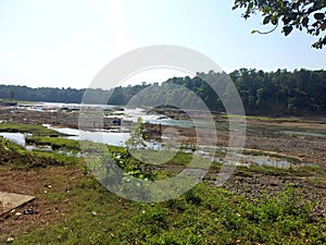 Landscape view of river get dry near waterfall and blue sky