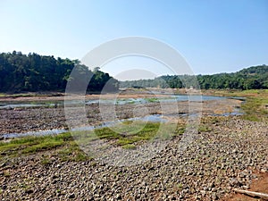 Landscape view of river get dry near waterfall and blue sky