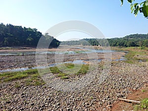 Landscape view of river get dry near waterfall and blue sky