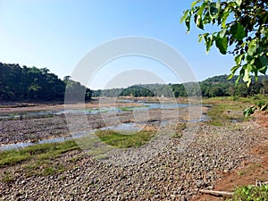 Landscape view of river get dry near waterfall and blue sky