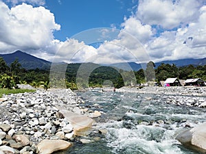 Landscape view with river and mountain background during sunny day