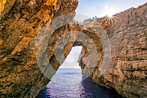 Landscape view of rocky formations with sun, Korakonissi in Zakynthos