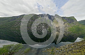 Landscape view of the rocky mountains reflected in water in Ardalsfjorden, Sognefjord area, Norway