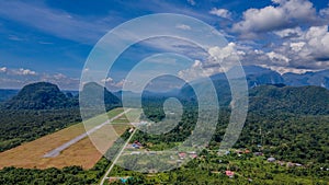 Landscape view of runway in secluded airport near tropical forest and mountains near Gunung Mulu national park. Borneo. Sarawak.