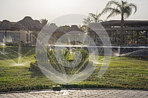 Landscape view of rural countryside park with water sprinklers