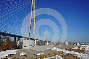 Landscape with a view of the Russian bridge against the blue sky