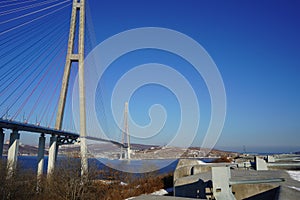 Landscape with a view of the Russian bridge against the blue sky