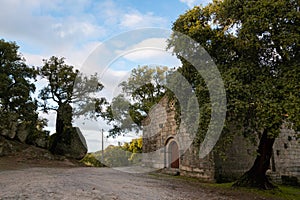 Landscape view of Sao Pedro chapel with trees and boulders in Monsanto, Portugal