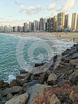 Landscape View of the sea and people in the sand and buildings at Praia de Iracema Beach, Fortaleza, CearÃÂ¡ Brazil photo