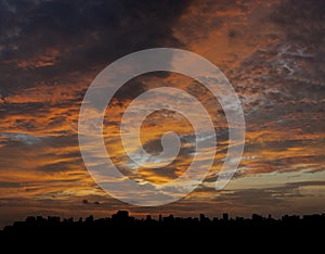 Landscape view of silhouette city in golden hour twilight sky before sunset