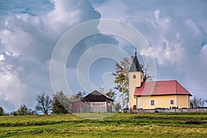 Landscape view of small church and cross sign on roof,