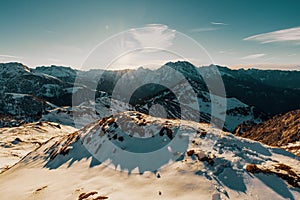 Landscape view of snowy Hohes Brett, the Berchtesgaden Alps with sky and sun shining background