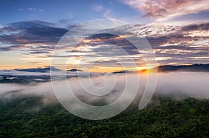 Landscape view of the sunrise, fog over moutains.